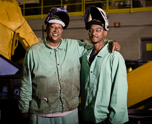 Image of two Goodwill Greenworks welders standing together