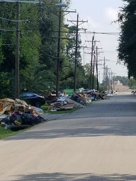 Debri lined up along the street outside of the damaged houses in Texas.