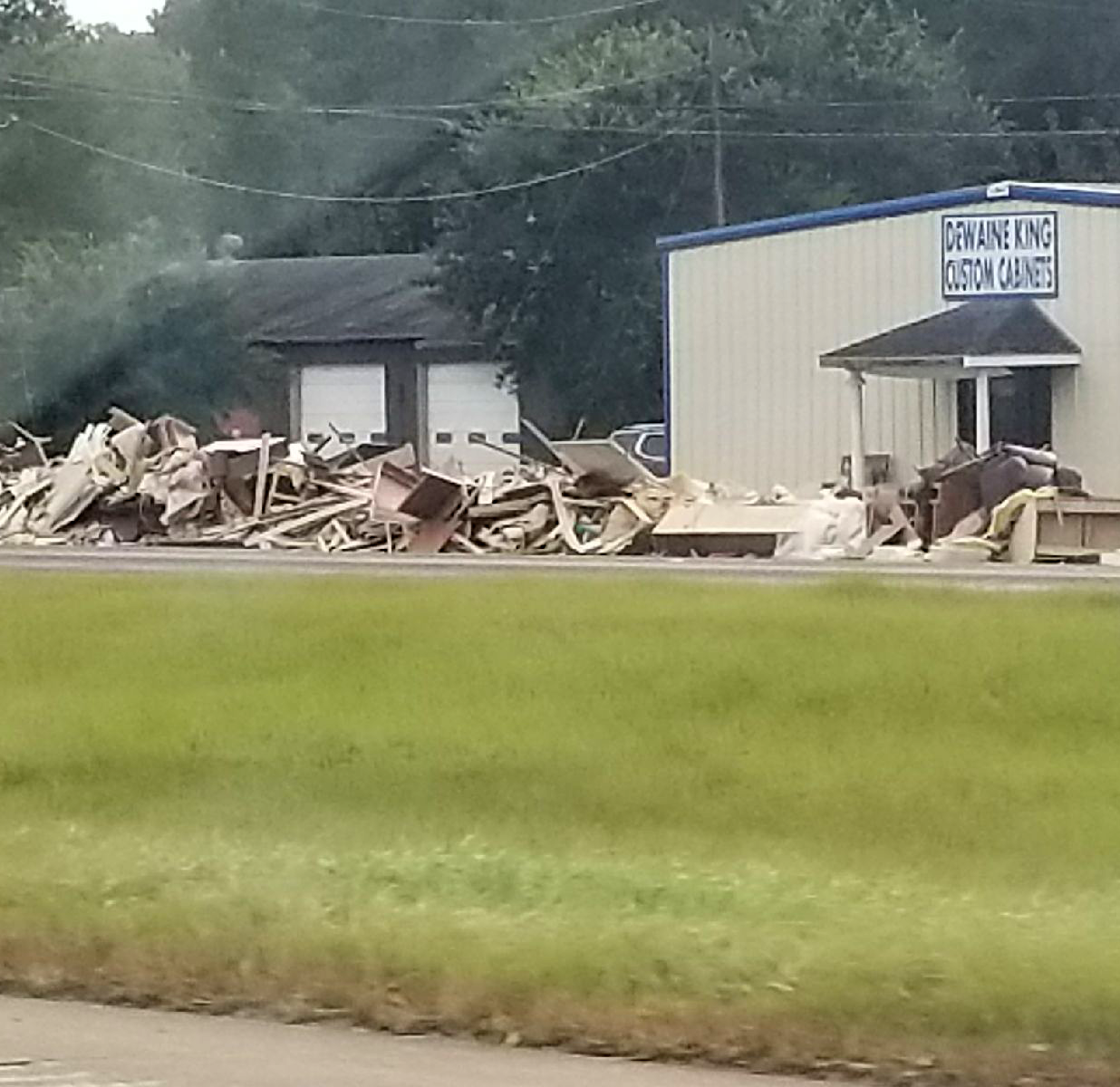 Debris lined up along the street outside of damaged businesses in Texas.